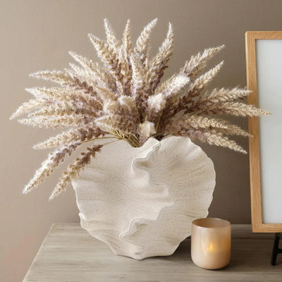 Elegant ceramic vase in cream tone, ideal for displaying dried or fresh flowers in contemporary interiors

